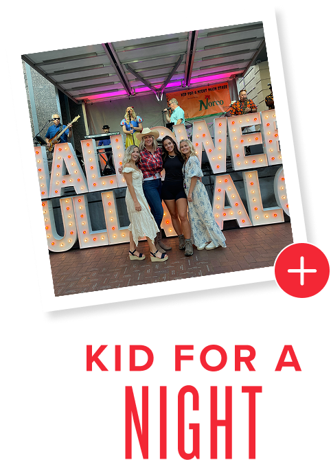 Kid for a Night - Women and girls in front of lighted sign