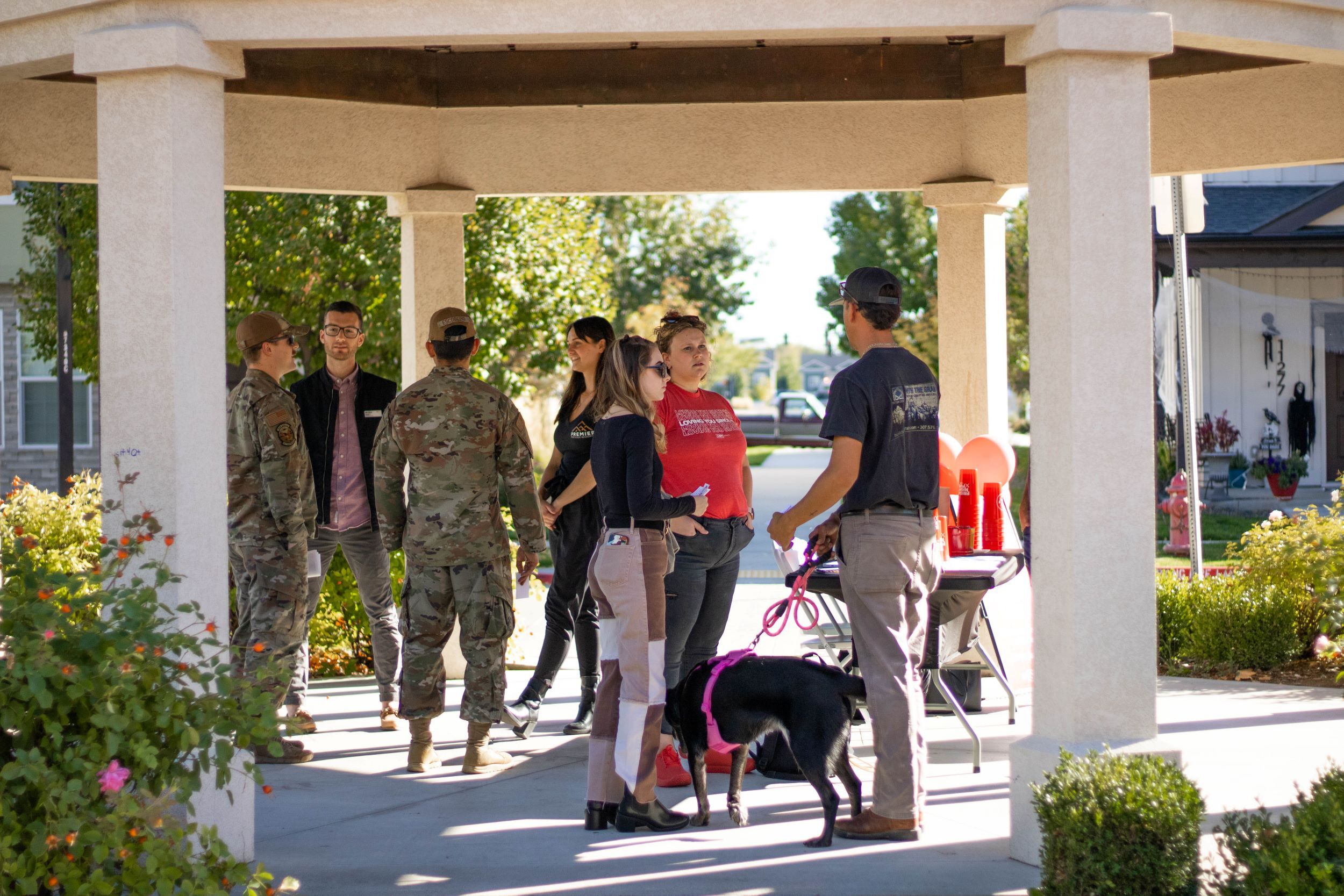 People in military fatigues talking with CBH agents