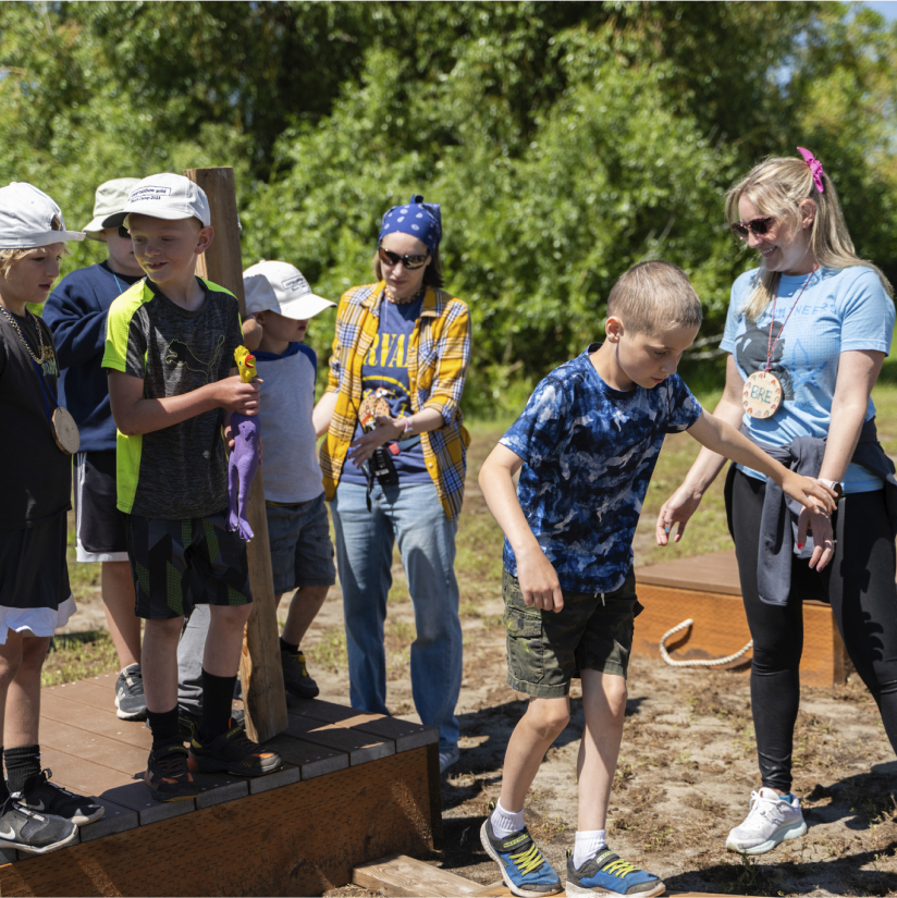 Kids on an outdoor balance beam